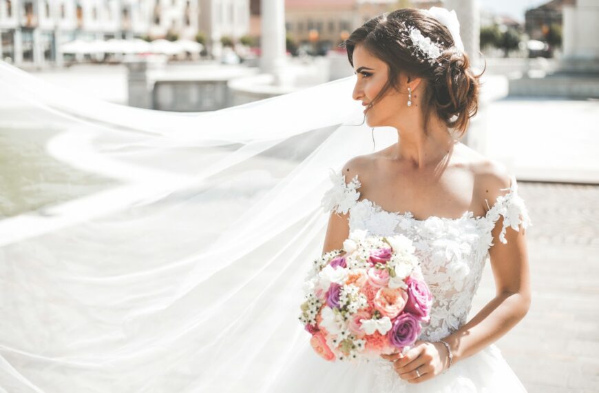 woman in white wedding dress holding bouquet of flowers