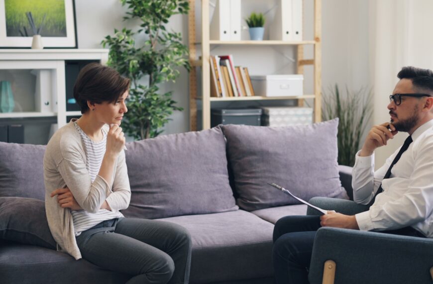 a man and a woman sitting on a couch talking