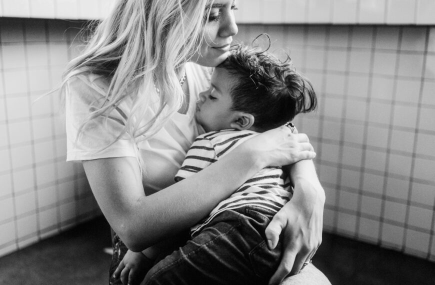 grayscale photo of man and woman kissing