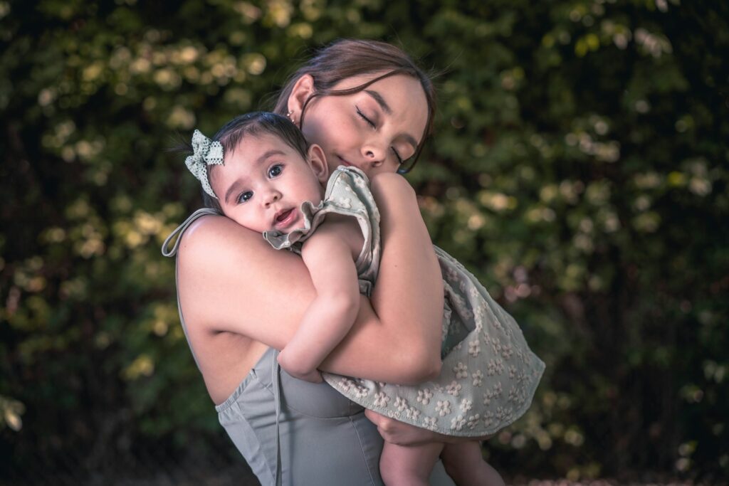 a woman holding a baby in her arms
