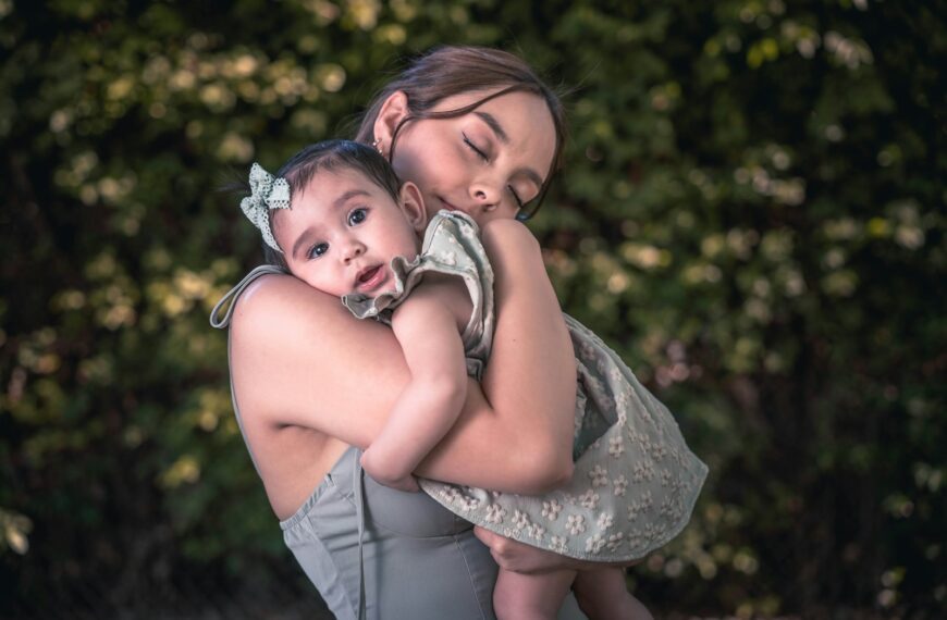a woman holding a baby in her arms