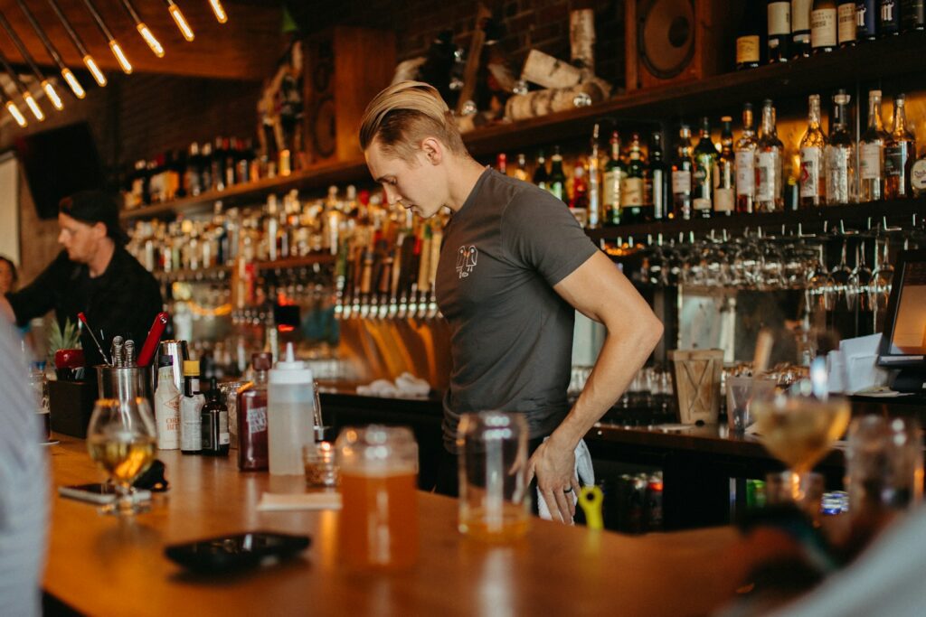 a man pouring a drink into a glass