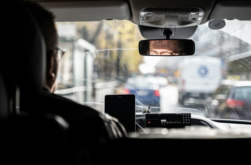 a man driving a car in the rain