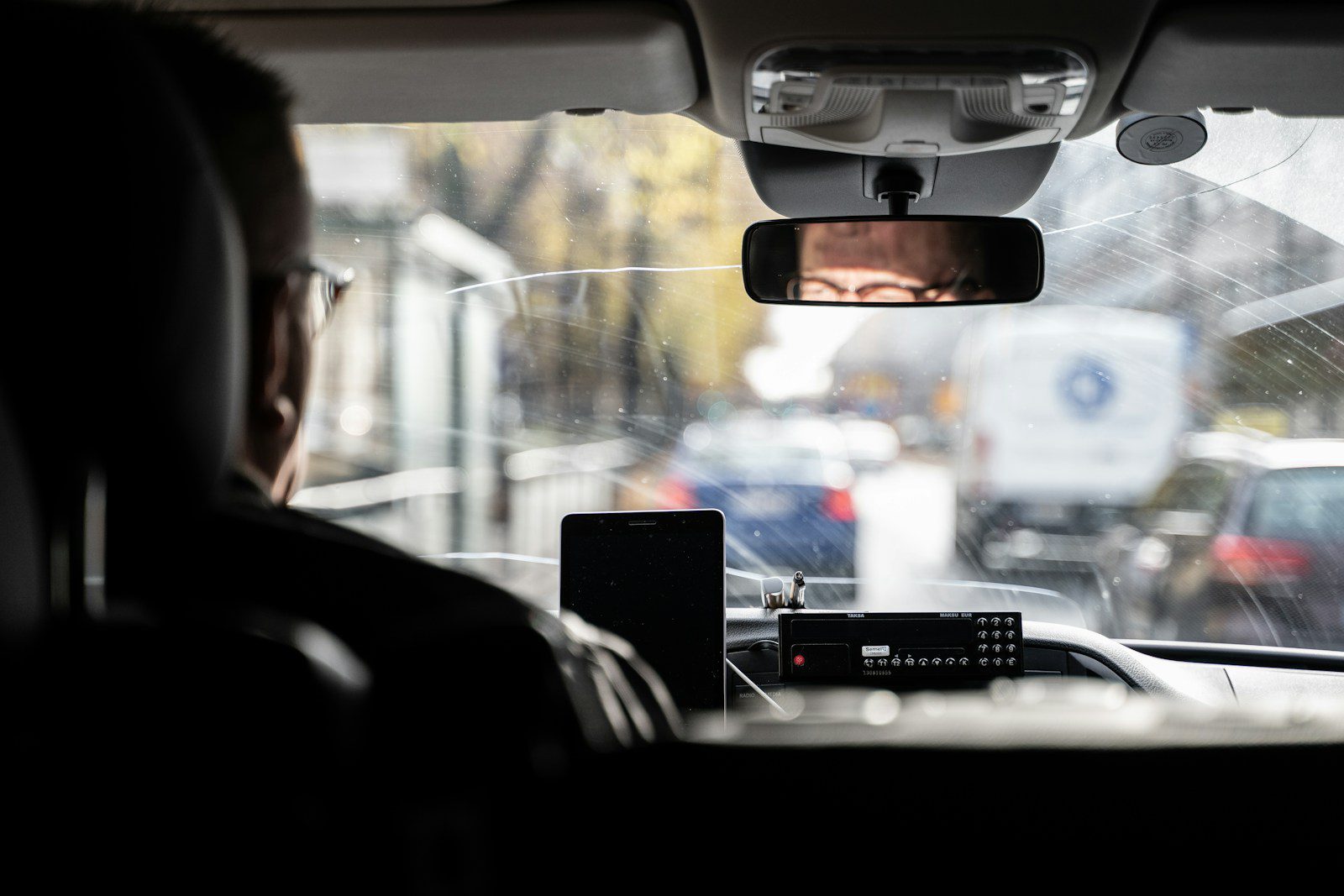a man driving a car in the rain