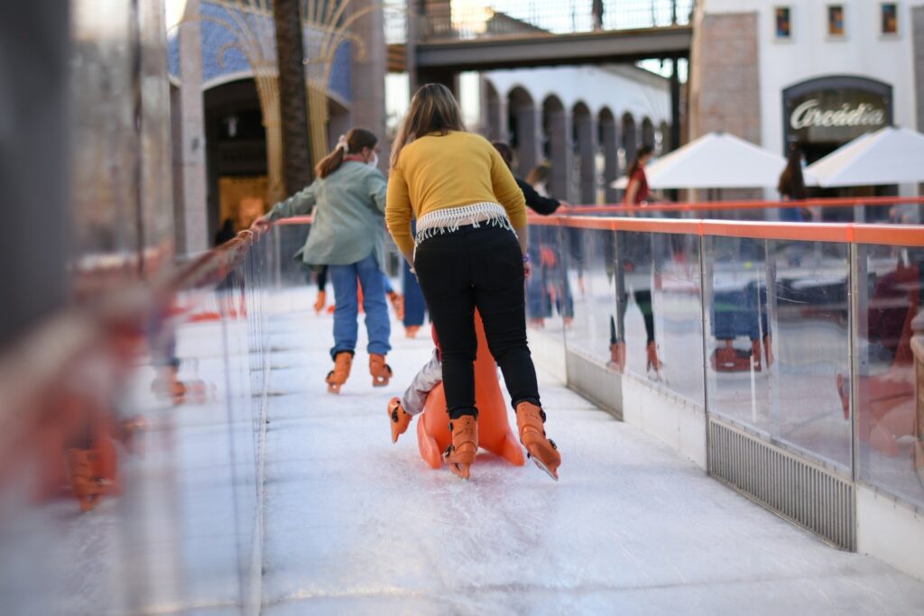 a group of people skating on an ice rink
