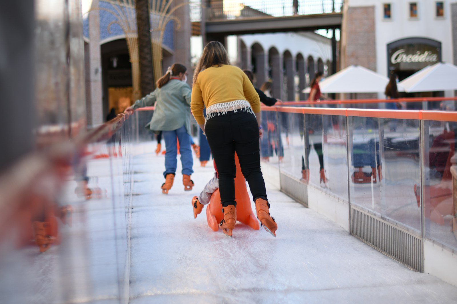a group of people skating on an ice rink
