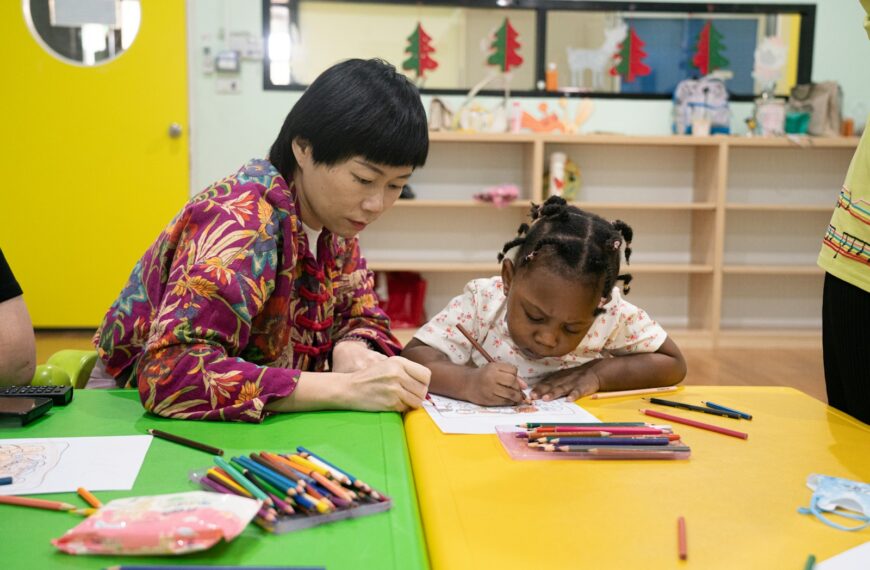 Adult and child drawing together at a table