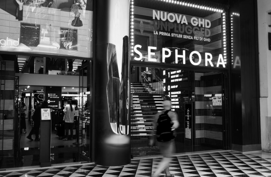 grayscale photo of people walking on sidewalk