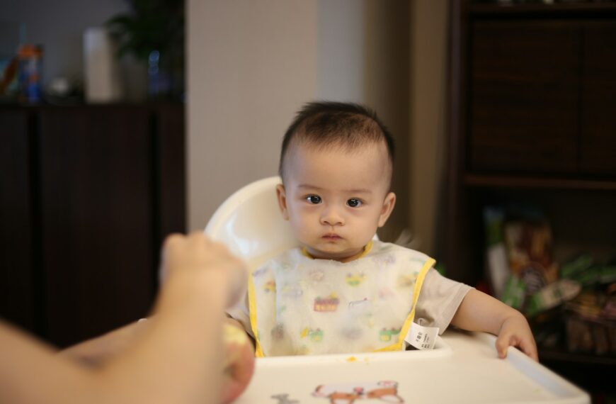 baby sitting on highchair