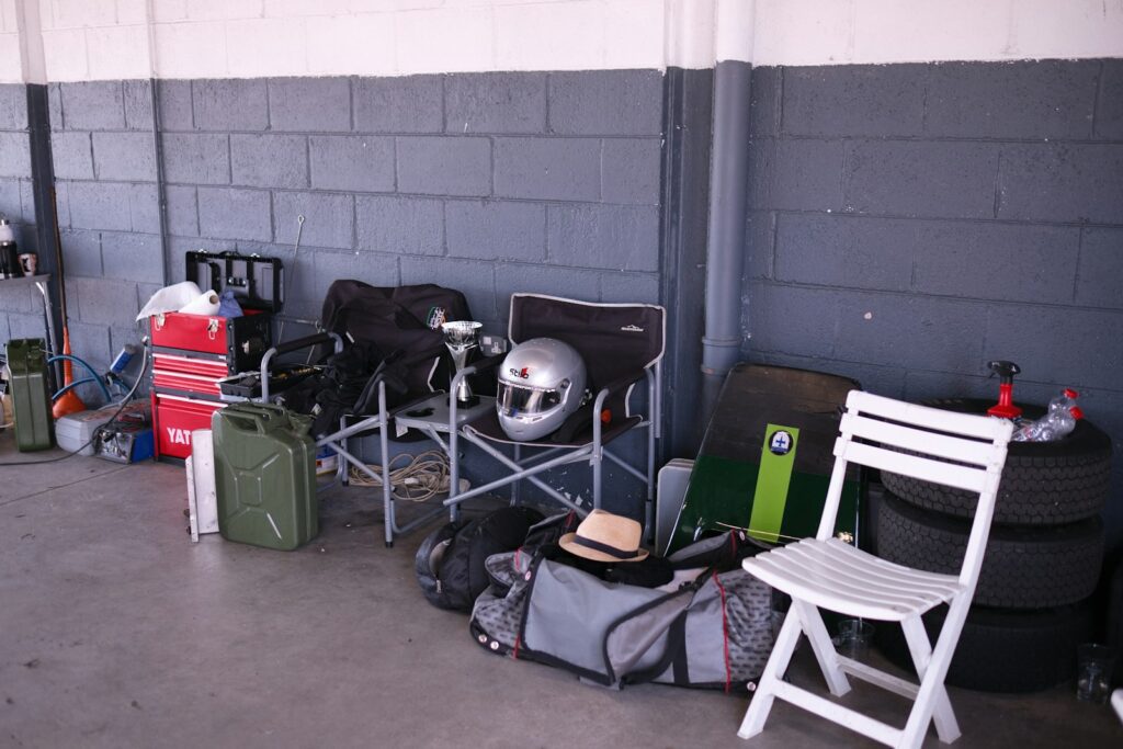 Racing gear and equipment stored against a brick wall