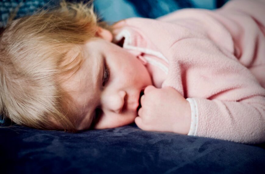 baby sleeping on black surface