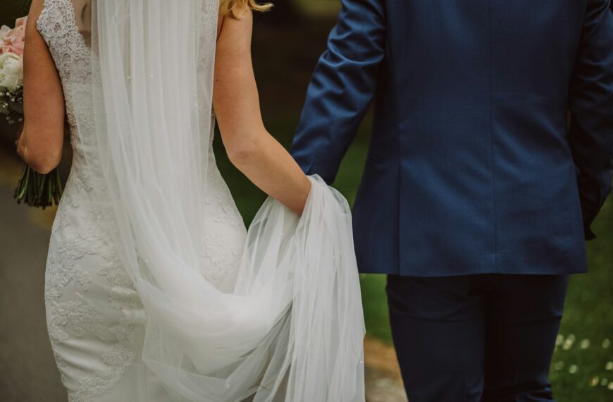 wedding couple holding hands while walking