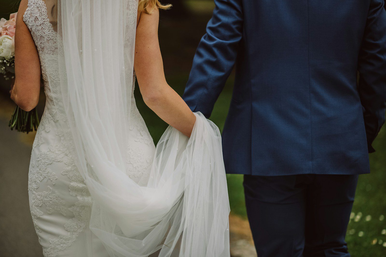 wedding couple holding hands while walking