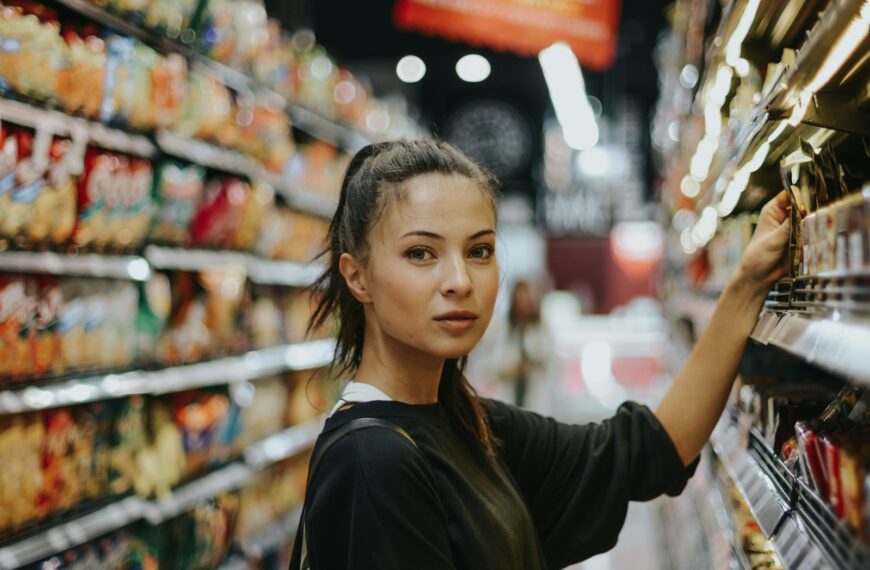 woman selecting packed food on gondola