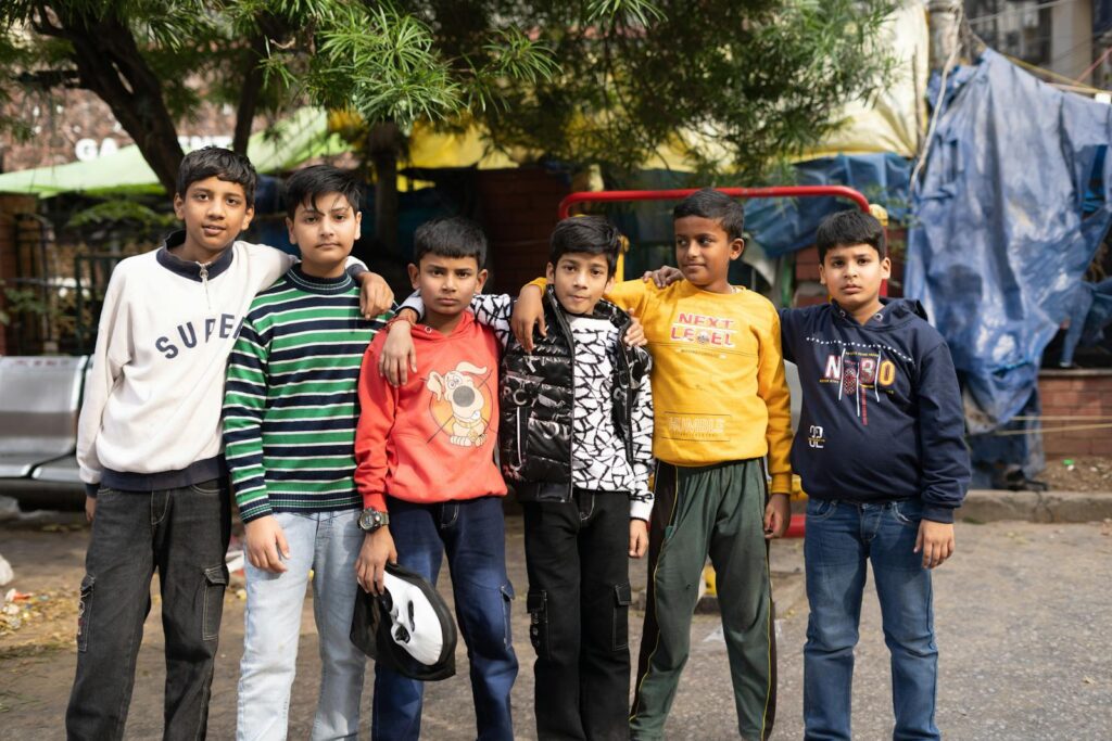 A group of young boys stands together on a street in Jammu, showcasing friendship and urban life.