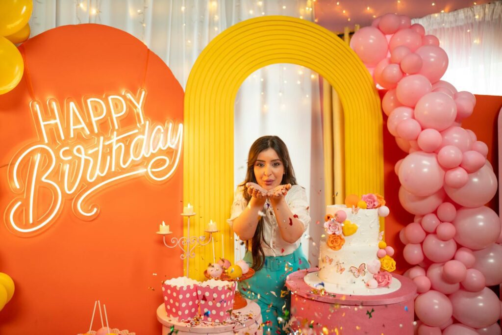 A festive birthday scene with a woman celebrating in colorful decor in Baghdad.