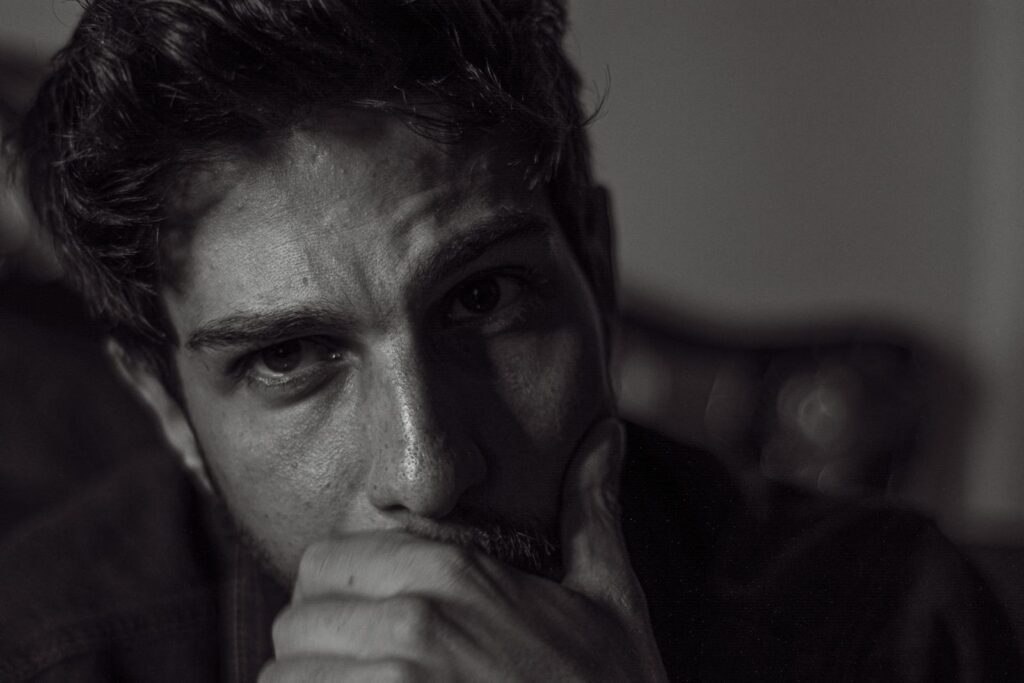 Expressive black and white portrait capturing deep thought and emotion.