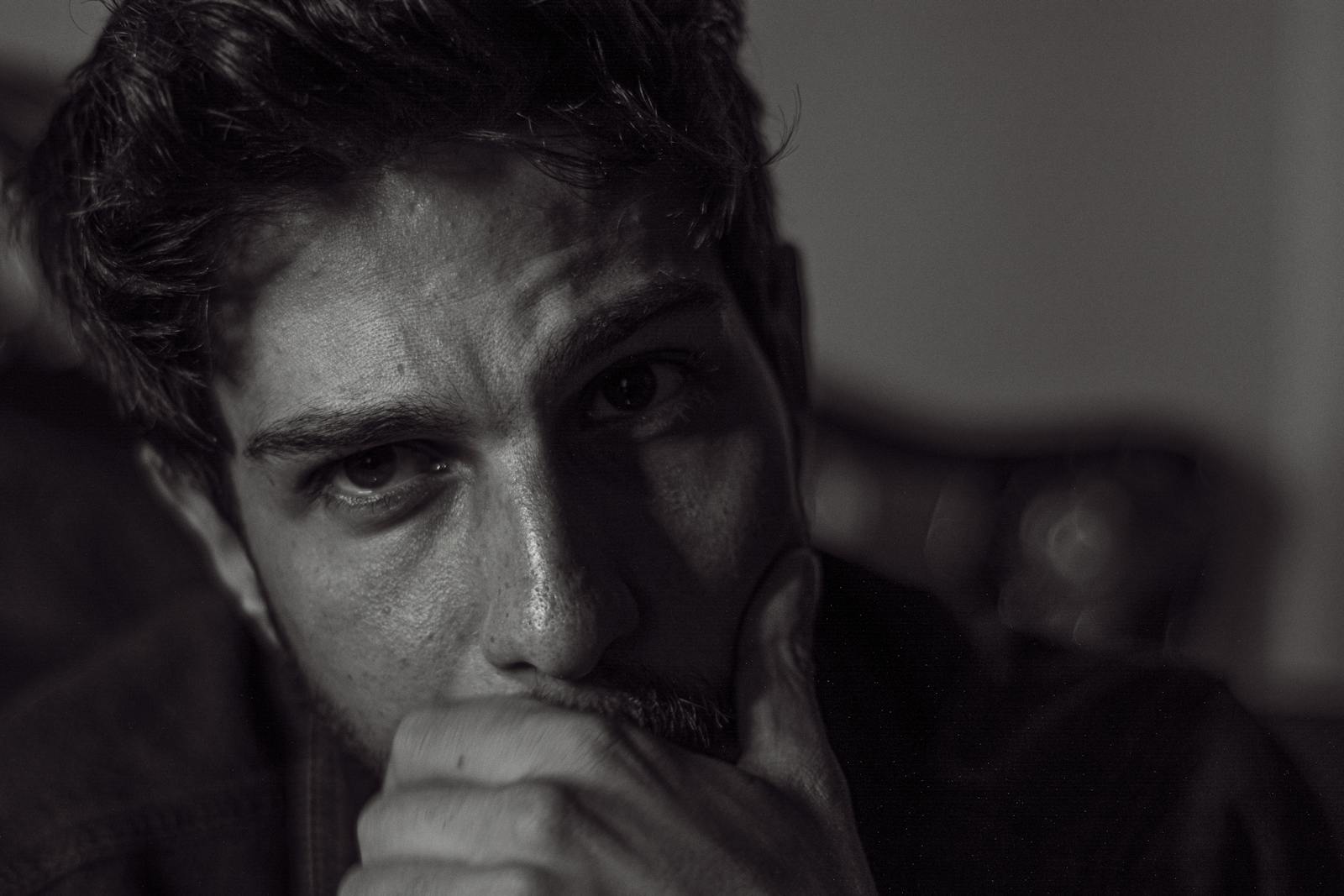 Expressive black and white portrait capturing deep thought and emotion.