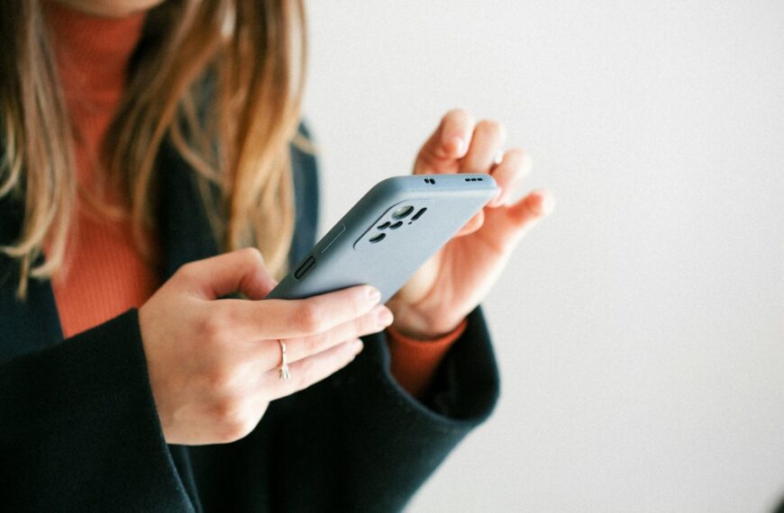 a woman holding a cell phone in her hands