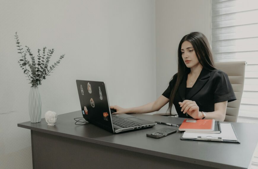 Woman working on a laptop at an office desk