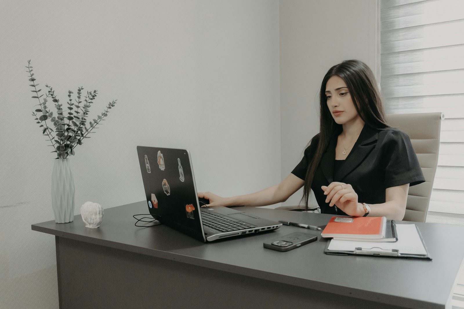 Woman working on a laptop at an office desk
