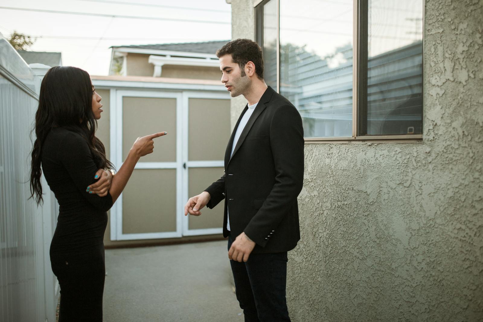 A tense moment captured between a man and a woman arguing outdoors.