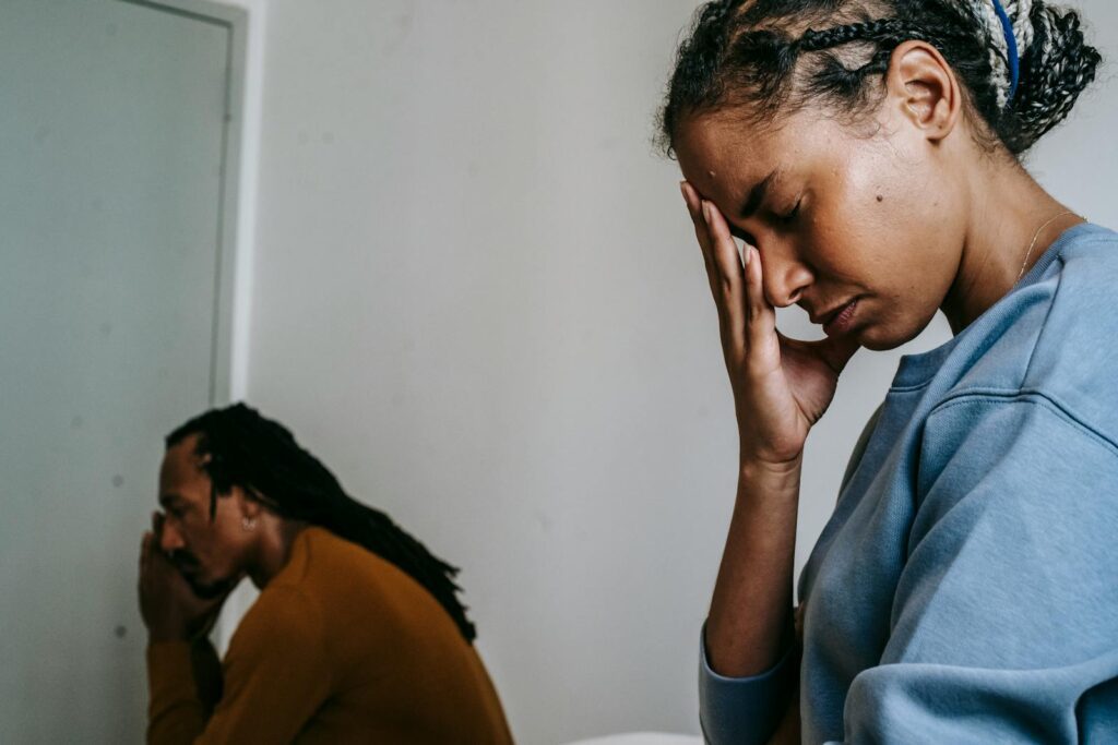Young black couple pastime with sad face and thinking in casual clothes in daytime