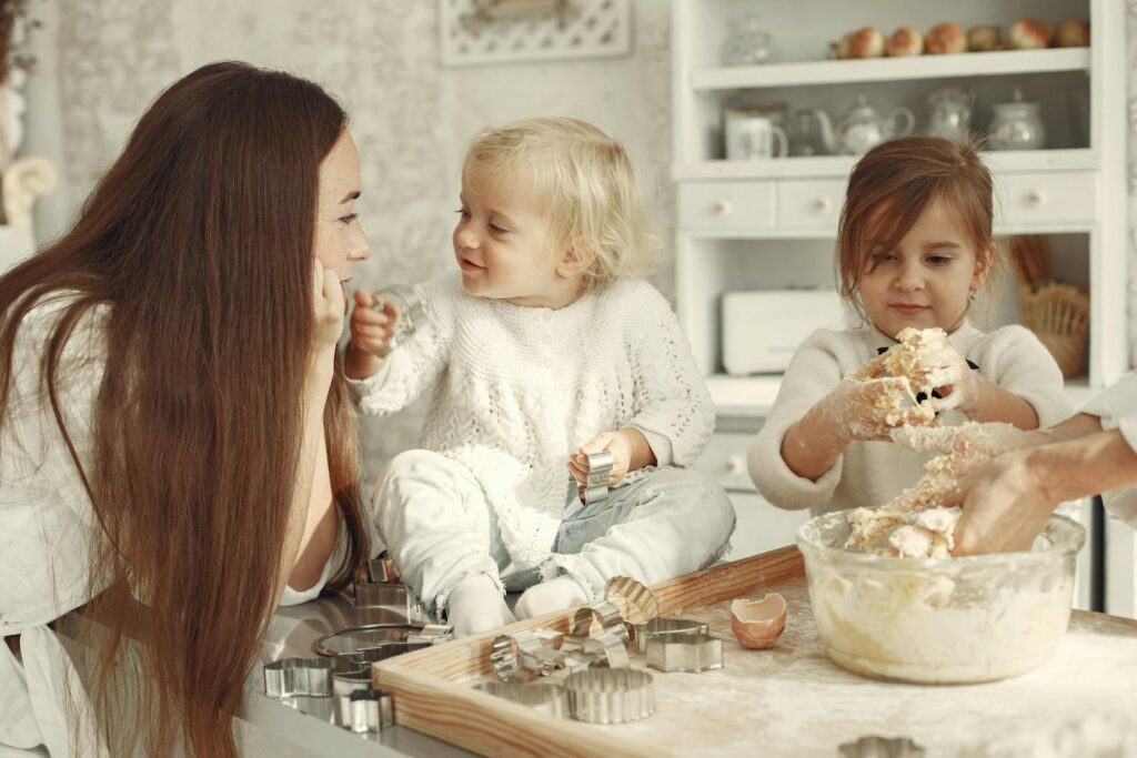 Happy family bonding while baking cookies in a cozy kitchen setting.