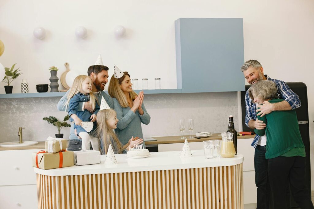 Family celebrating in a modern kitchen with cake, gifts, and happiness. Perfect for family and party themes.