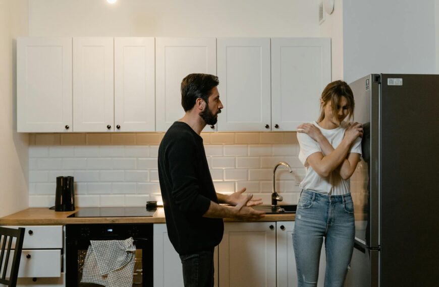 A couple argues in a modern kitchen, illustrating emotional tension and relationship challenges.