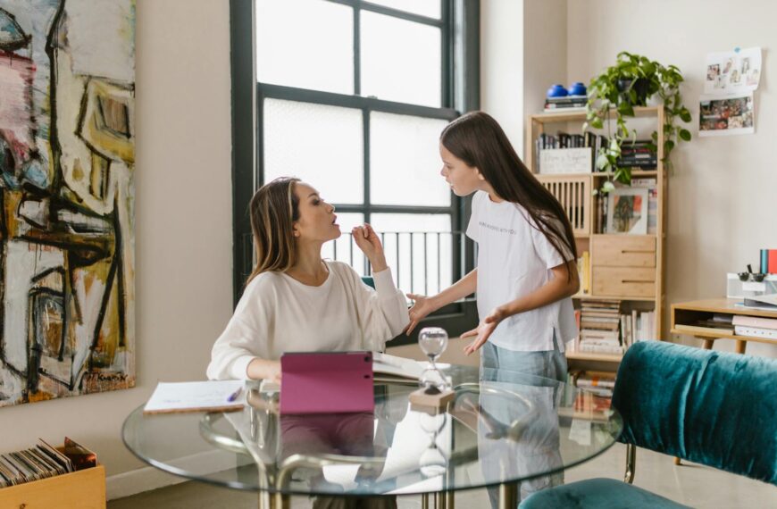 A mother and teenage daughter engage in a discussion at home, capturing family dynamics and emotions.