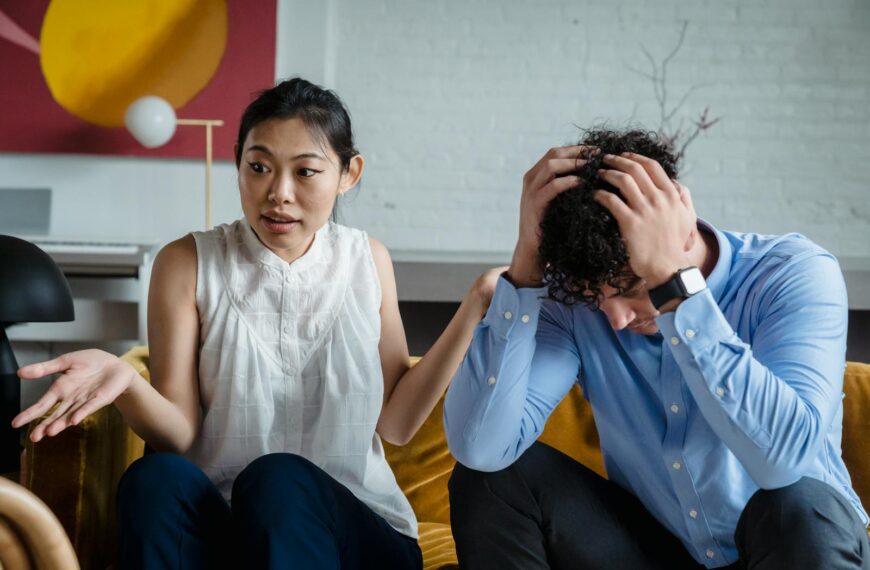 A couple having a serious conversation indoors, expressing emotions and misunderstanding.