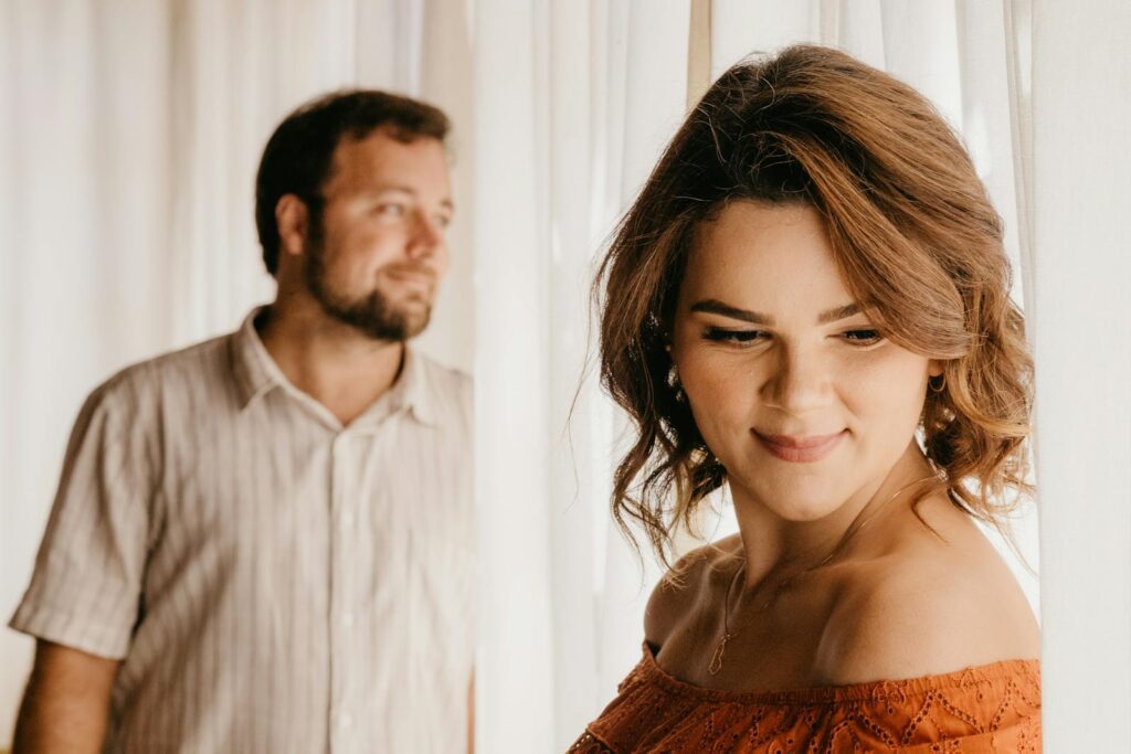 A couple indoors with soft natural lighting, conveying warmth and intimacy.