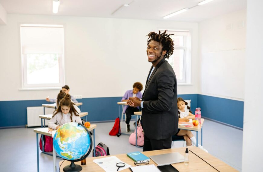 Teacher engaging with students in a bright classroom, promoting a positive learning environment.