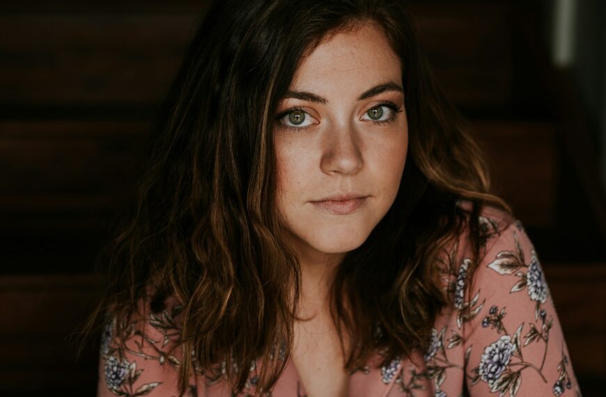 woman in peach and white floral top