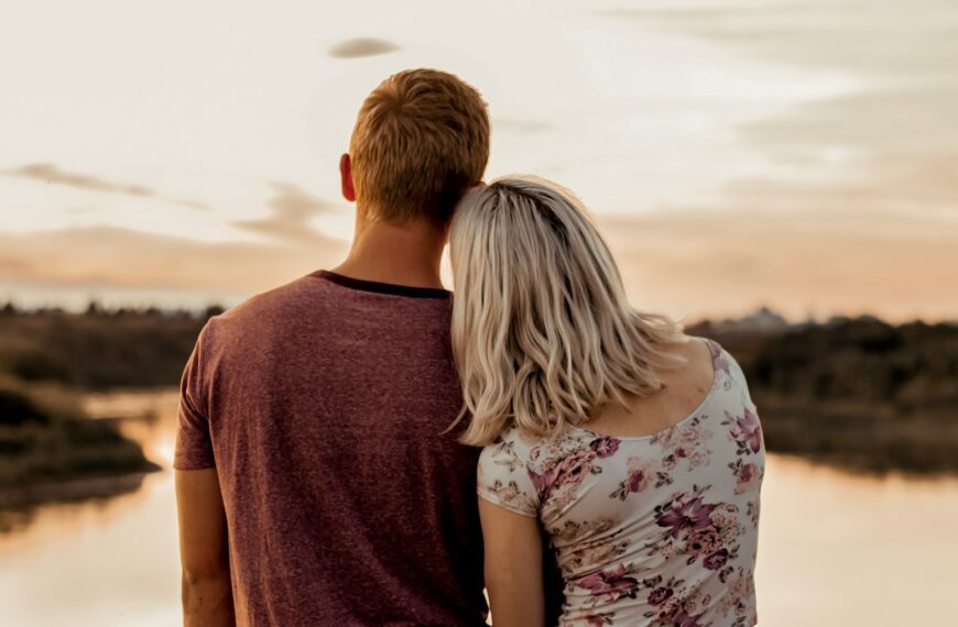man and woman standing on brown field during daytime