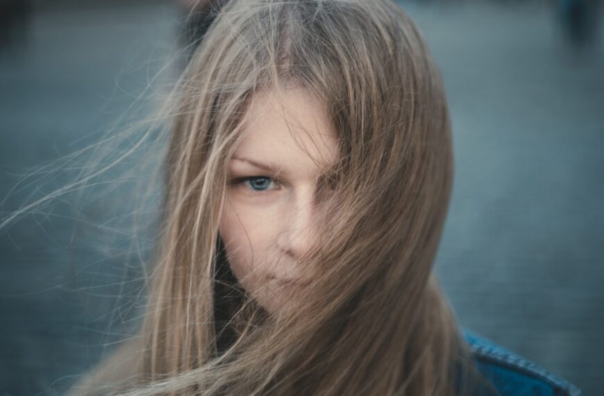 woman in blue shirt looking down