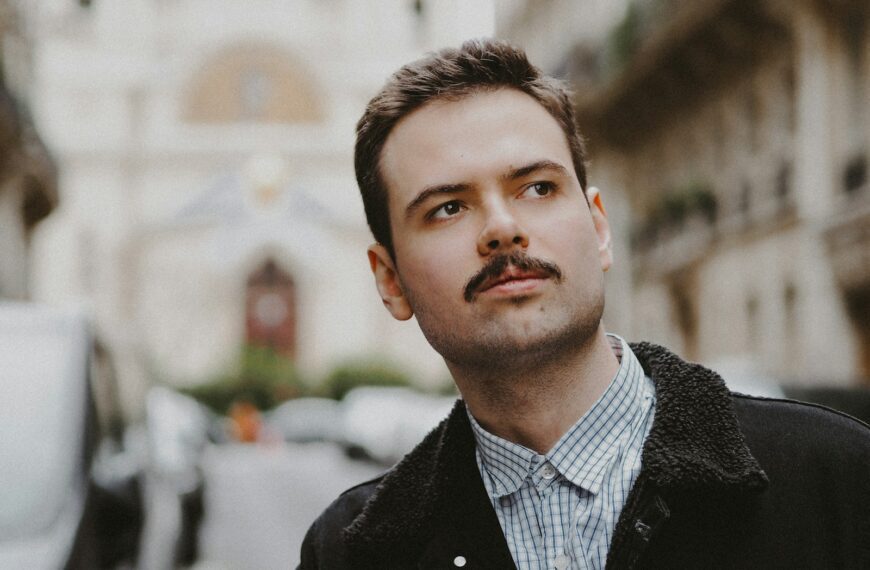 man in black coat standing during daytime