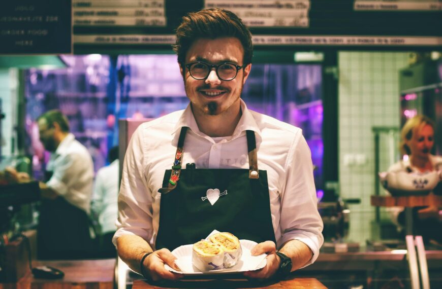 man holding fish dish on plate