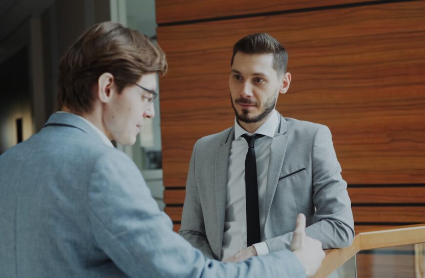 Two businessmen shaking hands in modern office