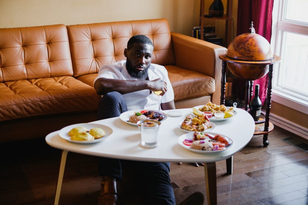 woman in gray long sleeve shirt sitting on brown leather couch