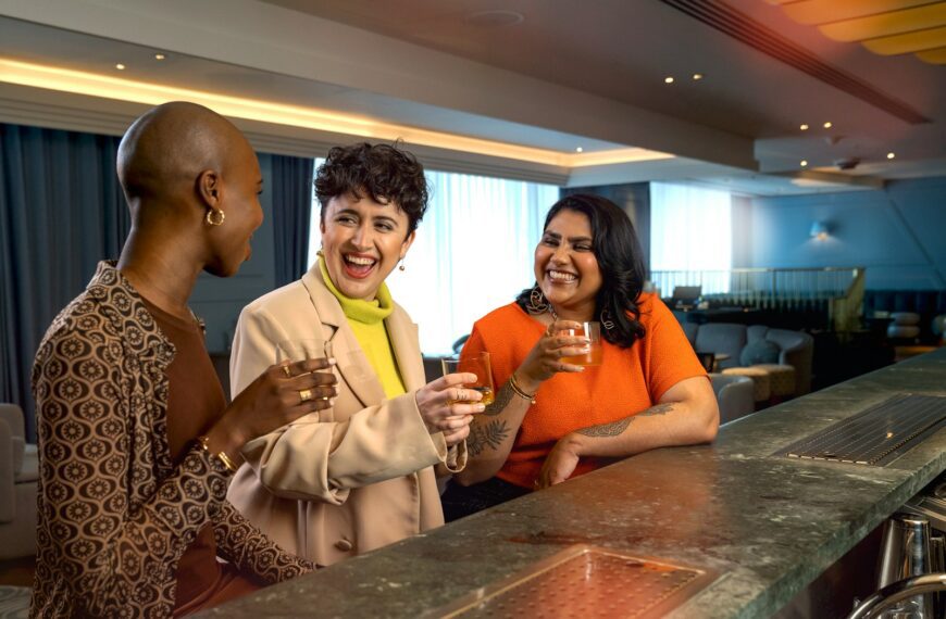a group of people standing around a bar