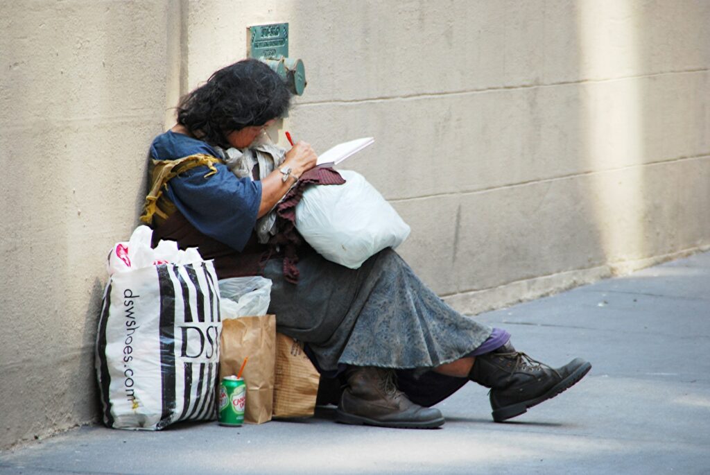 woman in black leather jacket sitting on concrete bench