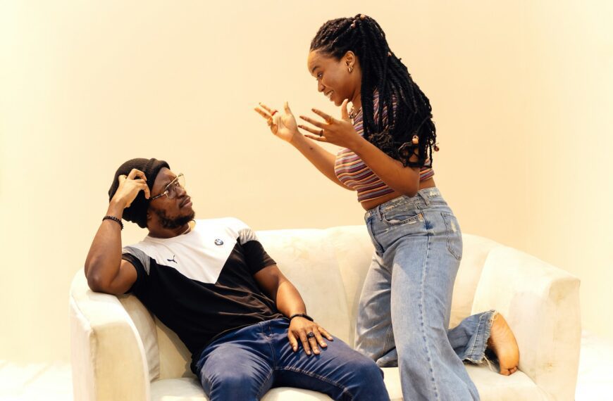 A man sitting on a couch next to a woman