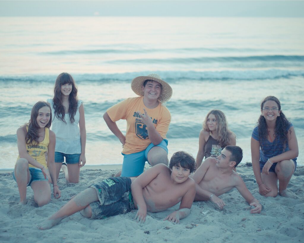 Group of friends posing on a sandy beach