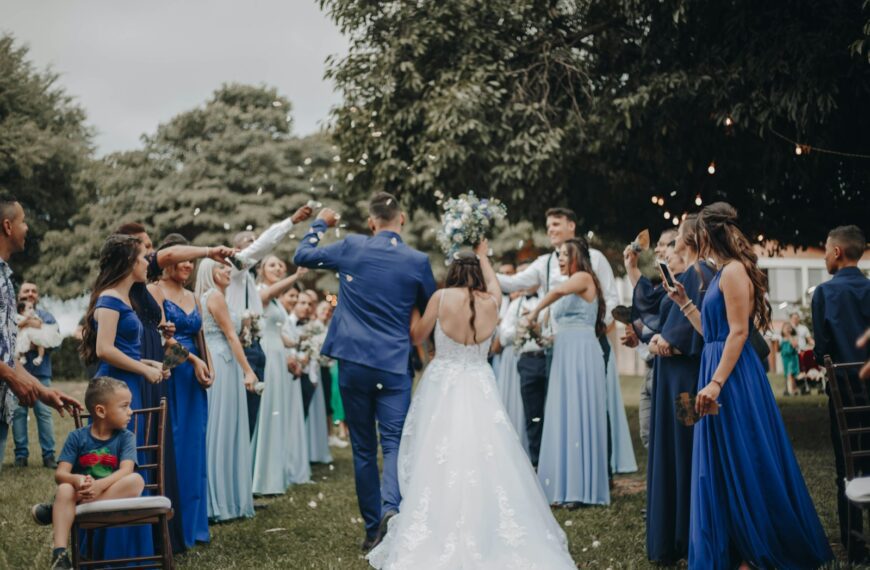people in white dress dancing on green grass field during daytime