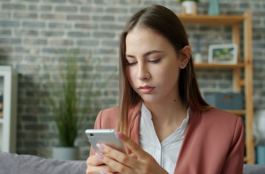 Young woman looking at her smartphone screen.