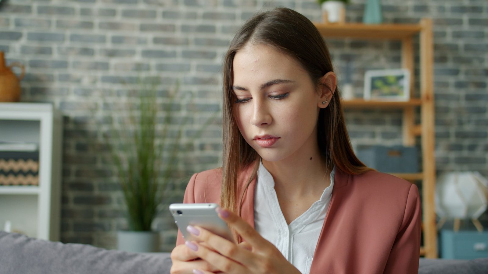 Young woman looking at her smartphone screen.