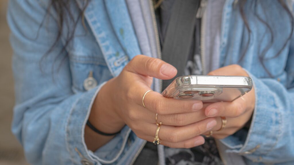 A woman holding a smart phone in her hands
