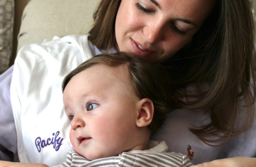 a woman holding a baby in her arms
